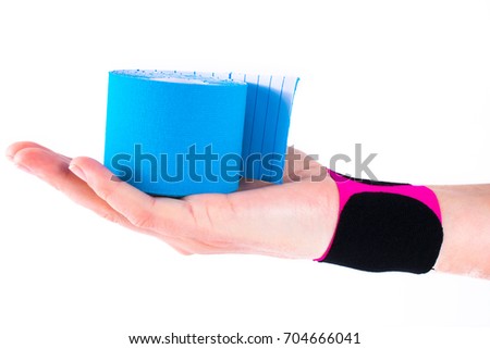 hand with kinesiology tape. Physiotherapy and therapeutic tape for wrist pain, aches and tension. elastic therapeutic tape. adhesive tape and alternative medicine.