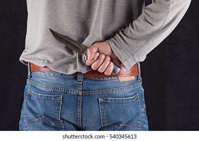 Hand With A Knife Behind His Back