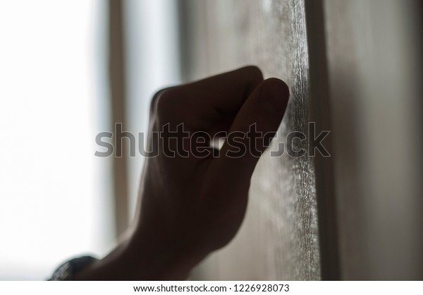 hand knocking on the\
door