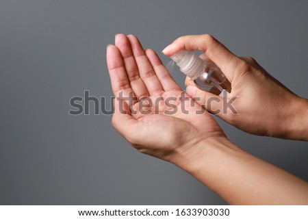 Hand of lady that applying alcohol spray or anti-bacteria spray to prevent the spread of germs, bacteria and virus. Personal hygiene concept.  Stockfoto © 