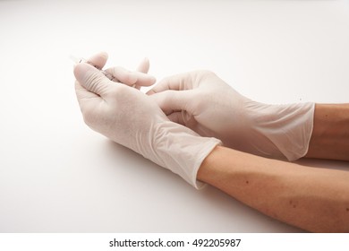 Hand In Latex Glove Holding Syringe Isolated On White Background