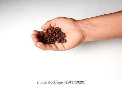 Hand of Latin man holding coffee beans on a soft background.
 - Powered by Shutterstock