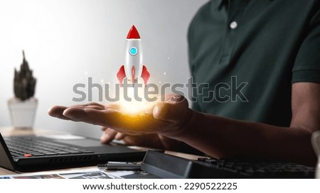 Hand launching a rocket soaring into the sky successful startup concept Leadership leads to success or business vision.