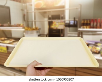Hand lifting food tray in food court for self service food. - Shutterstock ID 1080953207