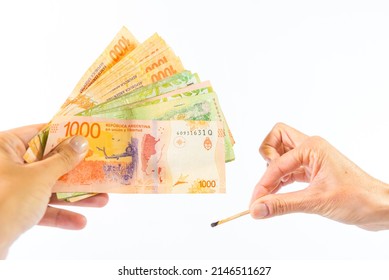 Hand Lighting Money On Fire With A Match, White Background, Finance Concept, Broken Economy