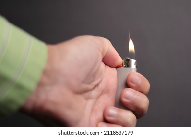 A Hand With A Lit Lighter