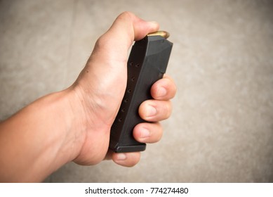 Hand Loading 9mm Bullets Into The Gun Magazine