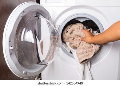 Hand loading laundry to the washing machine
