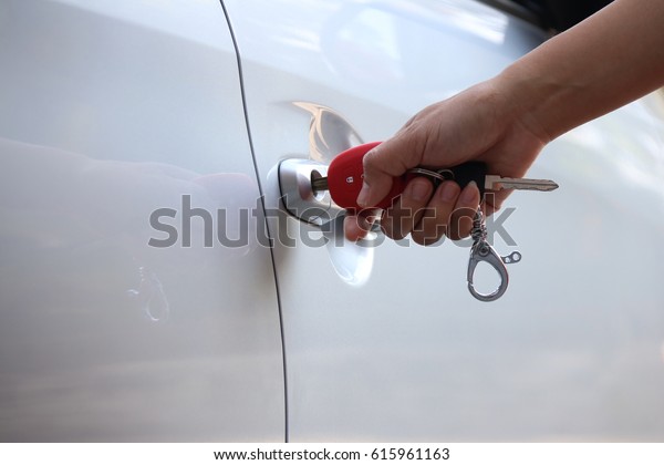 The\
hand is locking the key. For opening the car\
door