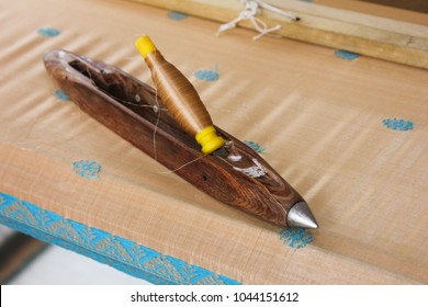 hand loom tool weaving shuttle and thread roll on Assam silk cloth