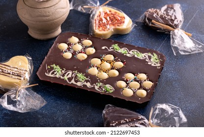 Hand Made Chocolate With Nuts On Blue Rustic Table.