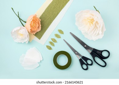 Hand Made Crepe Paper Flowers, Leaves, Scissors And Floral Tape Flat Lay.  Paper Peony DIY Concept