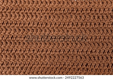 Hand made crochet pattern, textured brown abstract background, with horizontal lines, knitted threads texture close up