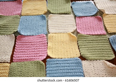 Hand Made Crochet Squares And Yarn Ready To Be Sewn Into A Baby Blanket