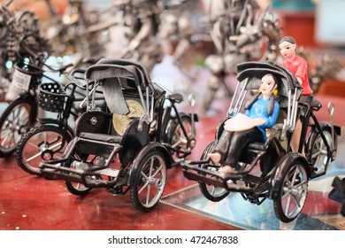 Hand made cycle with the image of Vietnamese woman in traditional dress. This is one of traditional and popular gift foreigner often purchase while visiting Vietnam. focus selective.