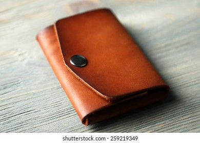 Hand made leather man wallet on wooden background