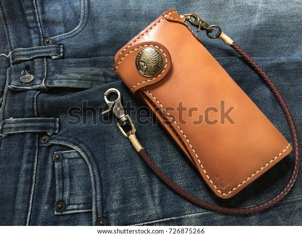 Hand made\
leather man wallet on Jeans\
background