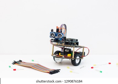 Hand Made Robot Working On The Arduino Platform. White Background. Free Space For Text. STEM Education For Children And Teenagers, Robotics And Electronics. DIY. AI. STEAM.