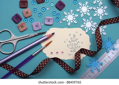 Hand Made Scrapbooking Post Card And Tools Lying On A Table