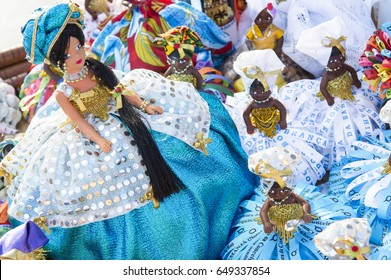 Hand made souvenir figurines of the Yoruba goddess Yemanja stand on display at the annual festival dedicated to her in Salvador, Bahia, Brazil