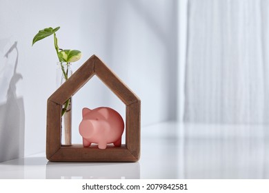 Hand Made Wooden House With With Piggy Bak Near Window