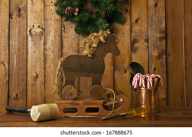 Hand Made Wooden Sled And Horse With Wood Background And Candy Canes In Foreground