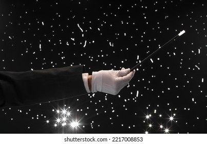 Hand With A Magic Wand On A Black Starry Background