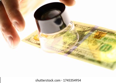 Hand With Magnifying Glass And Dollars, Money Check. Verify Authenticity Money. Verification Authenticity Banknotes Visually. Evaluate Paper From Which Banknotes Are Made. Counterfeit Money