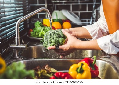 Hand of maid washing tomato fresh vegetables preparation healthy food in kitchen - Powered by Shutterstock