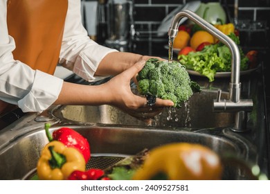 Hand of maid washing tomato fresh vegetables preparation healthy food in kitchen - Powered by Shutterstock