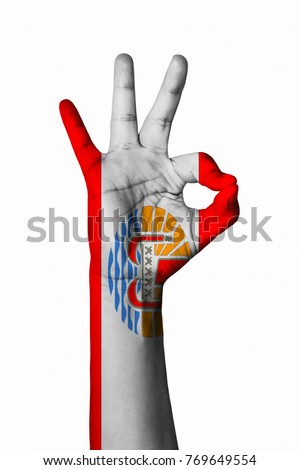 Hand making Ok sign, French polynesia flag painted as symbol of best quality, positivity and success - isolated on white background