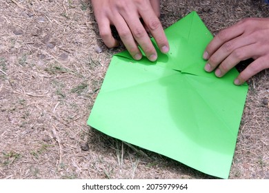 Hand Making Origami With Green Paper