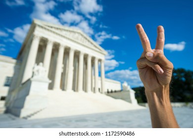 Hand Making Peace Symbol In Protest Of Current Political Discourse In Front Of US Supreme Court Building In Washington DC