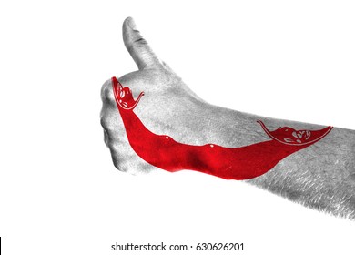 Hand making thumbs up sign. Easter Island Rapa Nui painted with flag as symbol of thumbs like,up,okay. Isolated on white background.