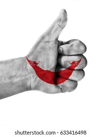 Hand making thumbs up sign. Easter Island Rapa Nui painted with flag as symbol of thumbs like,up,okay. Isolated on white background.