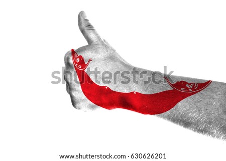 Hand making thumbs up sign. Easter Island Rapa Nui painted with flag as symbol of thumbs like,up,okay. Isolated on white background.