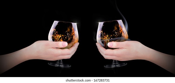 Hand Making Toast With Glass Splashing Cognac Or Brandy On Black Background