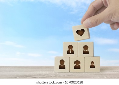 Hand of Male Arranging Wood Block Stacking with Icon Family, Add Love for Your Happy Home Concept