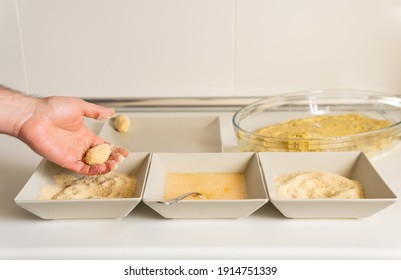 Hand Of A Male Making A Chicken Croquette. Taking The Dough And Dipping The Croquette In Egg And Bread Crumbs