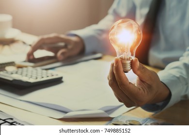 hand man accountant holding light bulb, new idea with innovation concept