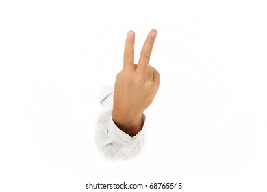 Hand Of Man Breaking Through A Paper Wall Showing Two Fingers. Counting Two. Copy Space. Studio Shot. White Background.