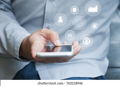 Hand of man in casual shirt touching smartphone with popup icons floating on cellphone after connected business world and applications in business , technology , finance  and communication concept - Shutterstock ID 763218946