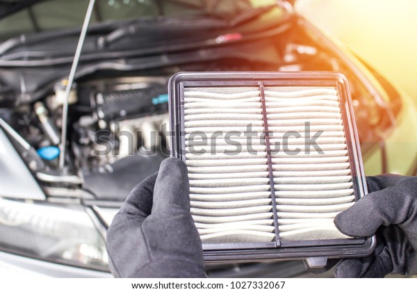 Hand a man change and check air filter of car in the\
engine room
