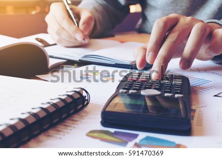 Hand man doing finances and calculate on desk about cost at home office.