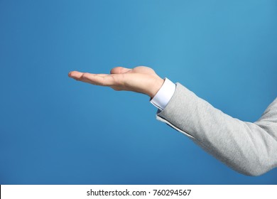 Hand Of Man In Formal Suit On Color Background