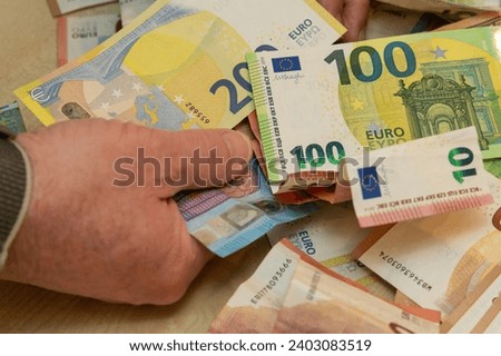 a hand of a man grabs of euro banknotes of high value [[stock_photo]] © 