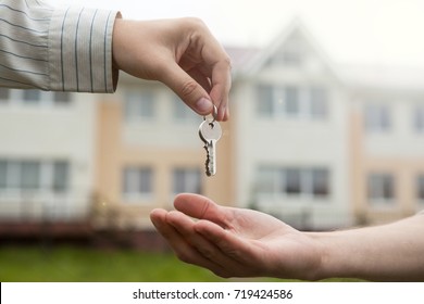 hand of a man handing keys to a man's hand - Shutterstock ID 719424586