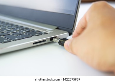 hand man hold Flash drive connect to USB port plug-in computer laptop for transfer data and backup business concept  - Shutterstock ID 1422375989