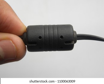 Hand Of Man Holding Black Color Ferrite Bead Inductor