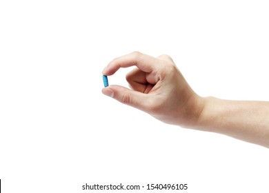 hand man holding blue pill on white background, close up